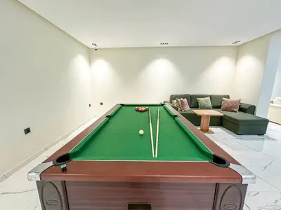 a pool table in a living room with a couch at Villa CAN 2025 & Chill Marrakech in Dar Caïd Layadi