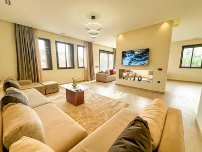 a large living room with a couch and a table at Villa CAN 2025 & Chill Marrakech in Dar Caïd Layadi