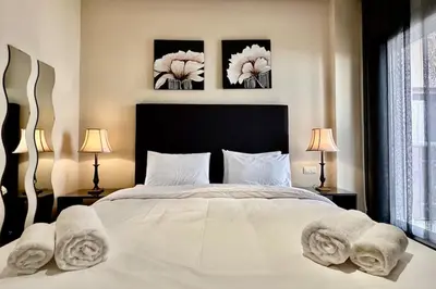 a bedroom with a large white bed with towels on it at 2 bedroom apartment in Plaza central Gueliz in Marrakech