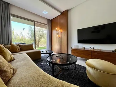 a living room with a couch and a flat screen tv at Prestigia Agate 5 minute from Airport in Marrakech