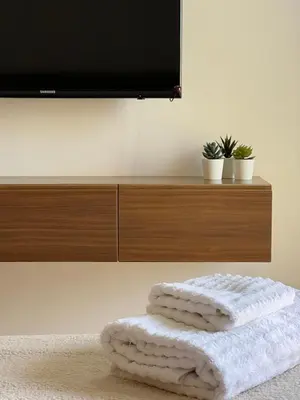 a pile of towels sitting on the floor in front of a television at Prestigia Agate 5 minute from Airport in Marrakech