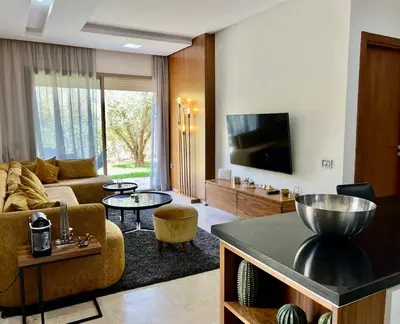 a living room with a couch and a tv at Prestigia Agate 5 minute from Airport in Marrakech