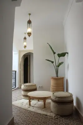 a living room with a bench and a potted plant at Riad de charme privatisé au cœur de la médina in Marrakech