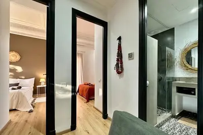 a living room with a mirror and a bedroom at Garden Aparment in Palmeraie 2 in Marrakech