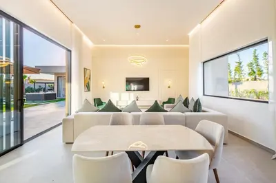 a living room with a table and a couch at Prestige Twin Villa with Splendid View in Marrakech