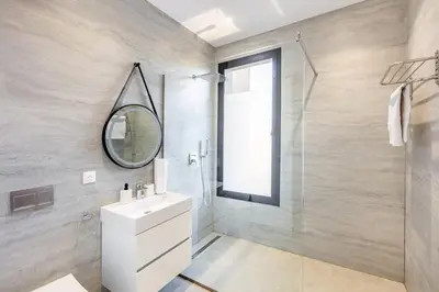 a bathroom with a sink and a mirror and a shower at Prestige Twin Villa with Splendid View in Marrakech