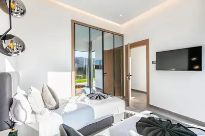 a living room with a bed and a tv at Prestige Twin Villa with Splendid View in Marrakech
