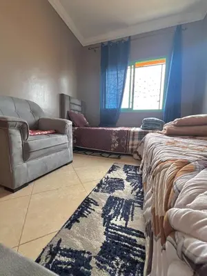 a living room with a couch and a couch and a rug at Modern Apt 10min Airport Balcony & Wi-Fi in Marrakech