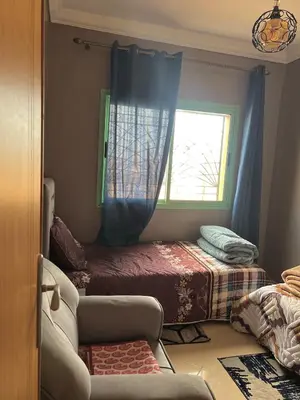 a bedroom with a bed and a window at Modern Apt 10min Airport Balcony & Wi-Fi in Marrakech