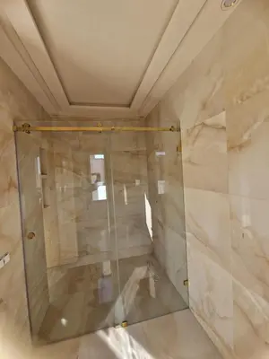 a shower with a glass door in a room at Luxury villa with heated pool and private Hammam in Marrakech