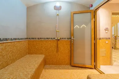 a shower with a glass door in a room at Luxury villa with heated pool and private Hammam in Marrakech