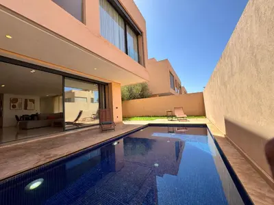 a swimming pool in the backyard of a house at Villa terracotta in Marrakech