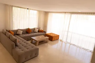 a living room with a couch and a table at Villa terracotta in Marrakech