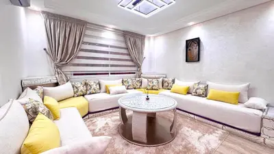 a living room with a couch and a table at Duplex Élégance et Confort avec piscine au Cœur de Marrakech in Marrakech