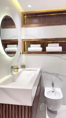a bathroom with a sink and a toilet and a mirror at Duplex Élégance et Confort avec piscine au Cœur de Marrakech in Marrakech