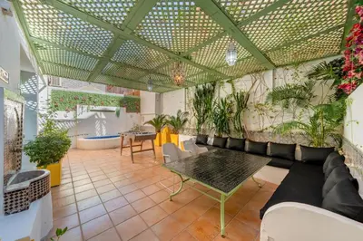 a room with a couch and a table and plants at Majorelle Place in Marrakech