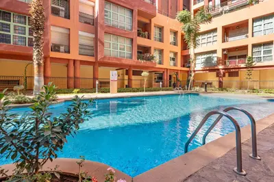 a swimming pool in front of a building at Majorelle Place in Marrakech