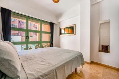 a bedroom with a bed and a window at Majorelle Place in Marrakech