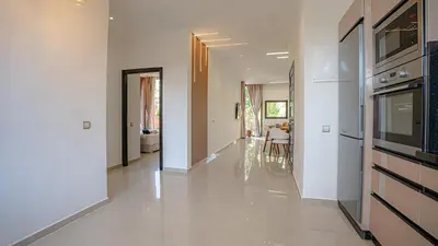 a hallway of a home with white walls at Appart calme & central, piscine, proche médina et place Jemaa El Fna in Marrakech