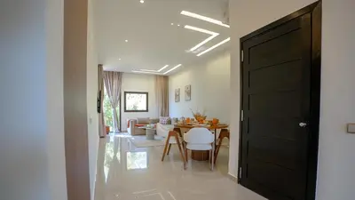 a hallway with a living room and a dining room at Appart calme & central, piscine, proche médina et place Jemaa El Fna in Marrakech