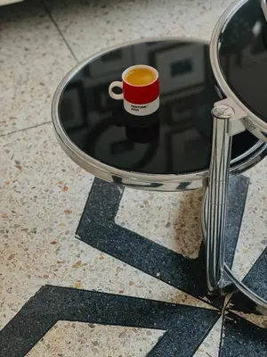 a cup of coffee sitting on a table at Designer apartment with south-facing terrace in Marrakech