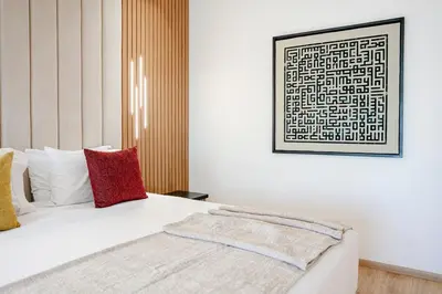 a bedroom with a white bed with red pillows at Villa Nerolia - Marrakech in Marrakech