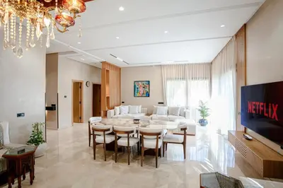 a large living room with a table and chairs at Villa Nerolia - Marrakech in Marrakech