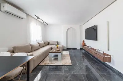 a living room with a couch and a tv at Appartement au cœur de Guéliz in Marrakech