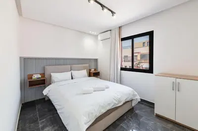 a bedroom with a large bed and a window at Appartement au cœur de Guéliz in Marrakech