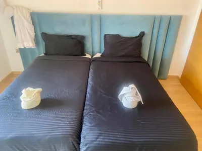 two beds with shoes on them in a bedroom at prestigia urbane appartement marrakech in Marrakech