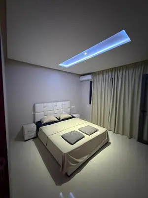 a bedroom with a bed and a blue light at Appartement Marrakech route de casa in Marrakech
