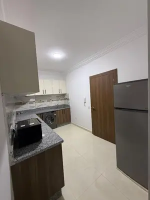 a kitchen with a refrigerator and a counter top at Appartement Marrakech route de casa in Marrakech
