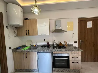 a kitchen with a sink and a stove top oven at Apartments city center in Marrakech
