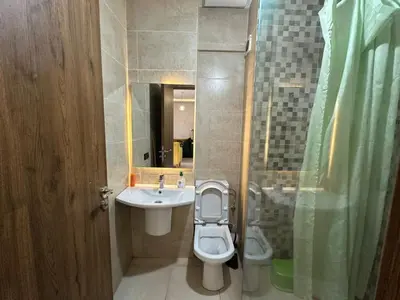 a bathroom with a toilet and a sink and a mirror at Apartments city center in Marrakech