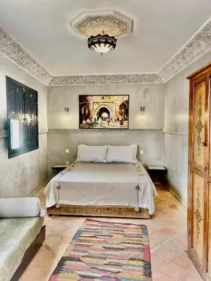 a bedroom with a large bed and a rug at Riad alwafa B&B in Marrakech