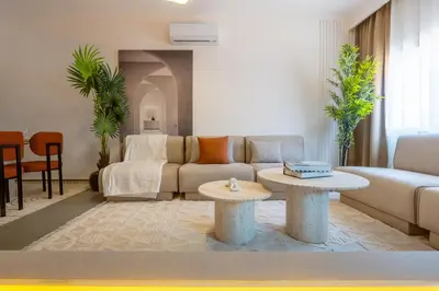 a living room with a couch and a table at Spacieux 2BR à Guéliz, Centre-Ville, Moderne et Confortable in Marrakech