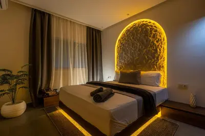 a bedroom with a bed with a gold head board at Spacieux 2BR à Guéliz, Centre-Ville, Moderne et Confortable in Marrakech