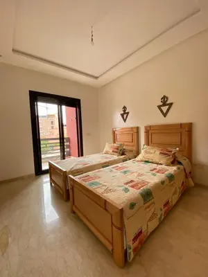a bedroom with two beds and a window at Marrakech Apartment with Pool in Marrakech