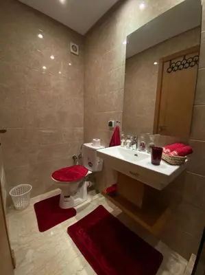 a bathroom with a sink and a toilet and a mirror at Marrakech Apartment with Pool in Marrakech