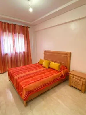a bedroom with a large bed with yellow pillows at Marrakech Apartment with Pool in Marrakech