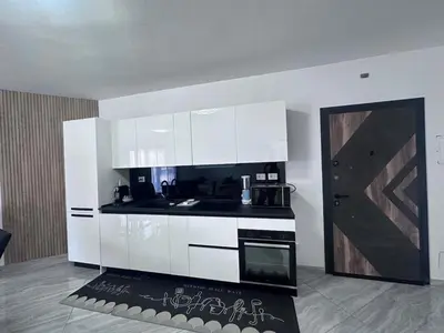 a kitchen with white cabinets and a stove top oven at Appartement Vacances FTS Little in Marrakech