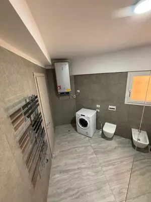 a bathroom with a washing machine and a toilet at Appartement Vacances FTS Little in Marrakech