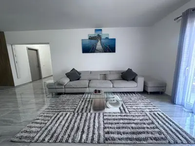 a living room with a couch and a table at Appartement Vacances FTS Little in Marrakech