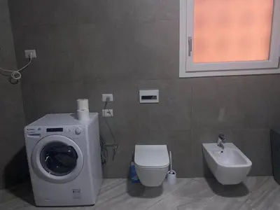a bathroom with a washing machine and a sink at Appartement Vacances FTS Little in Marrakech