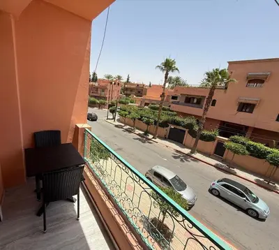 a balcony with a view of a street with cars at Appartement Vacances FTS Little in Marrakech
