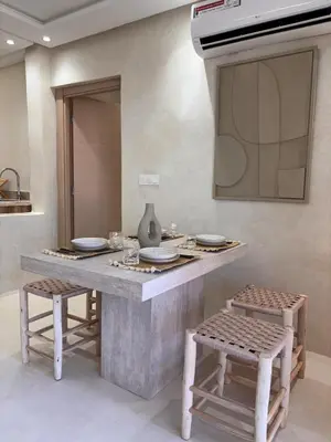 a kitchen with a counter with two stools and a sink at Dar Kamyssa Le désert au cœur de Guéliz in Marrakech