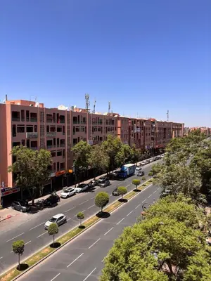 an aerial view of a city street with parked cars at Dar Kamyssa Le désert au cœur de Guéliz in Marrakech