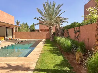 a swimming pool in the backyard of a house at Villa AYA - Moderne & Chic in Sraghna