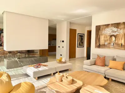 a living room with a couch and a table at Villa AYA - Moderne & Chic in Sraghna