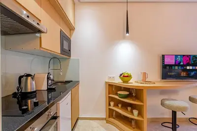 a kitchen with a counter and a table in a room at Central 1BR Studio- AC & IpTV-Self check in- 2 guests in Marrakech